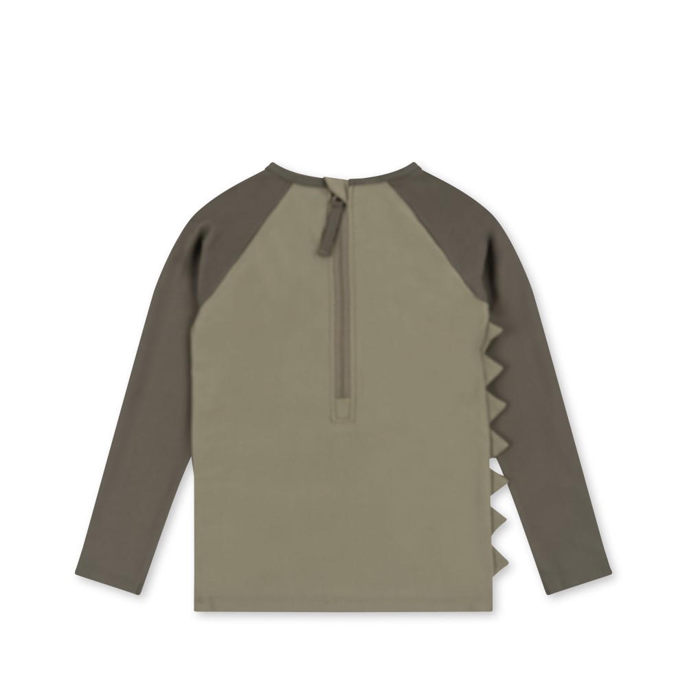 KS4621-ASTER-SWIM-BLOUSE-DINO-OVERLAND-TREK-Extra-1 Kinder-Langarmshirt, khaki, dunkle Raglanärmel, Rückenzipper, Dinosaurier-Zacken an der Seite.
