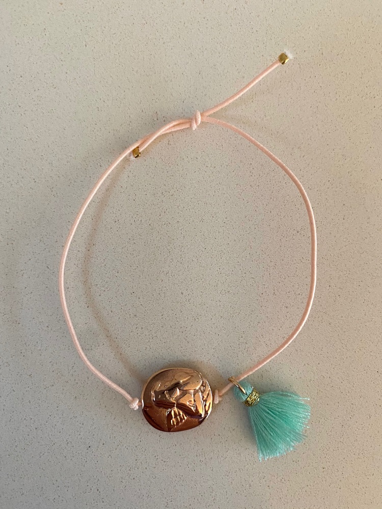 IMG_0858 Armband; zartes rosa Band; goldener runder Anhänger mit Pferdemotiv; mintgrüner Quastenanhänger.