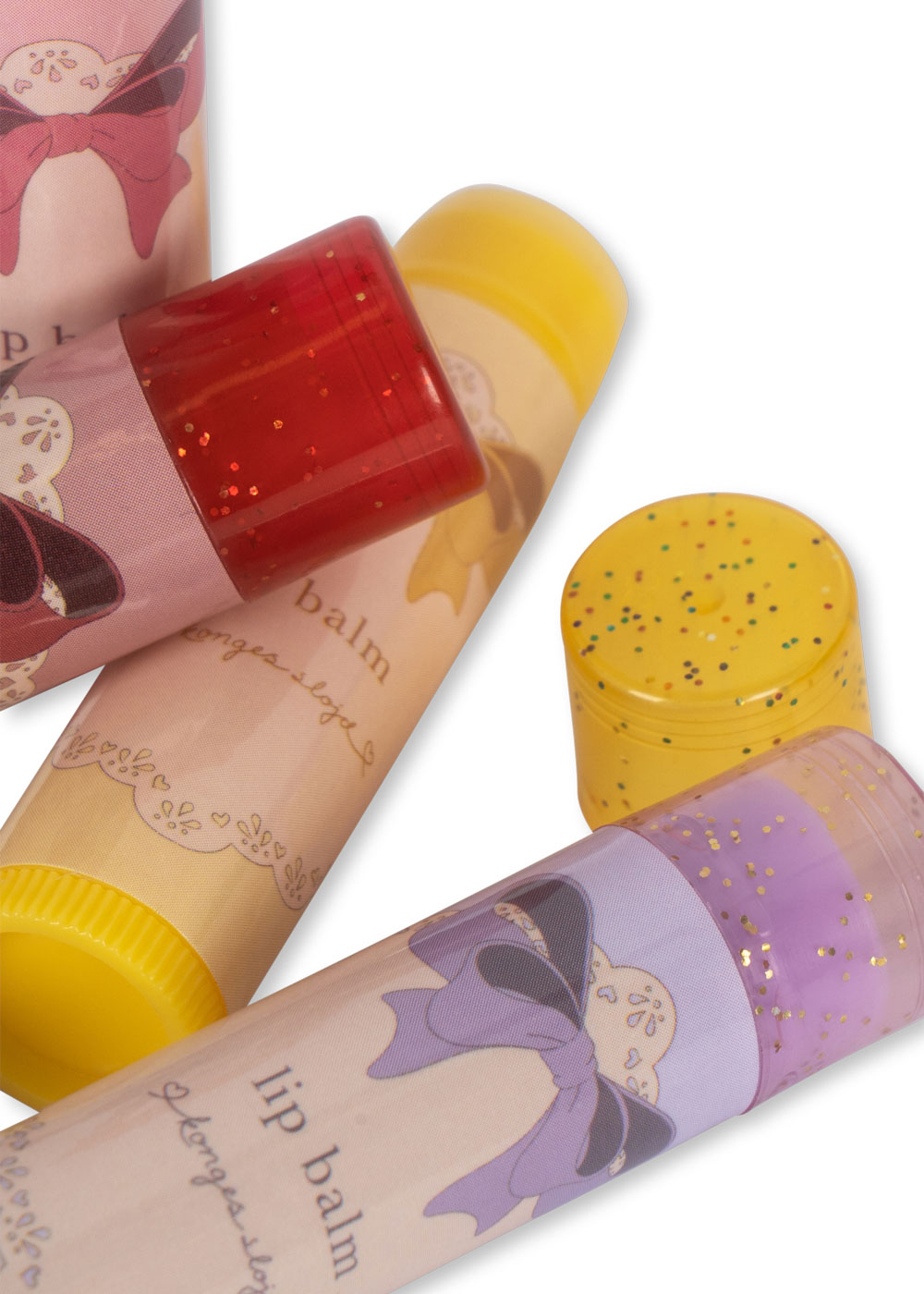 Lippenbalsam, verschiedene Farben, gelbes und rotes Glitzerdesign, Verpackung mit Schleifenaufdruck.
