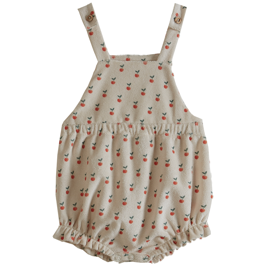 Baby-Strampler, beige, Kirschmuster, Träger mit Knöpfen.