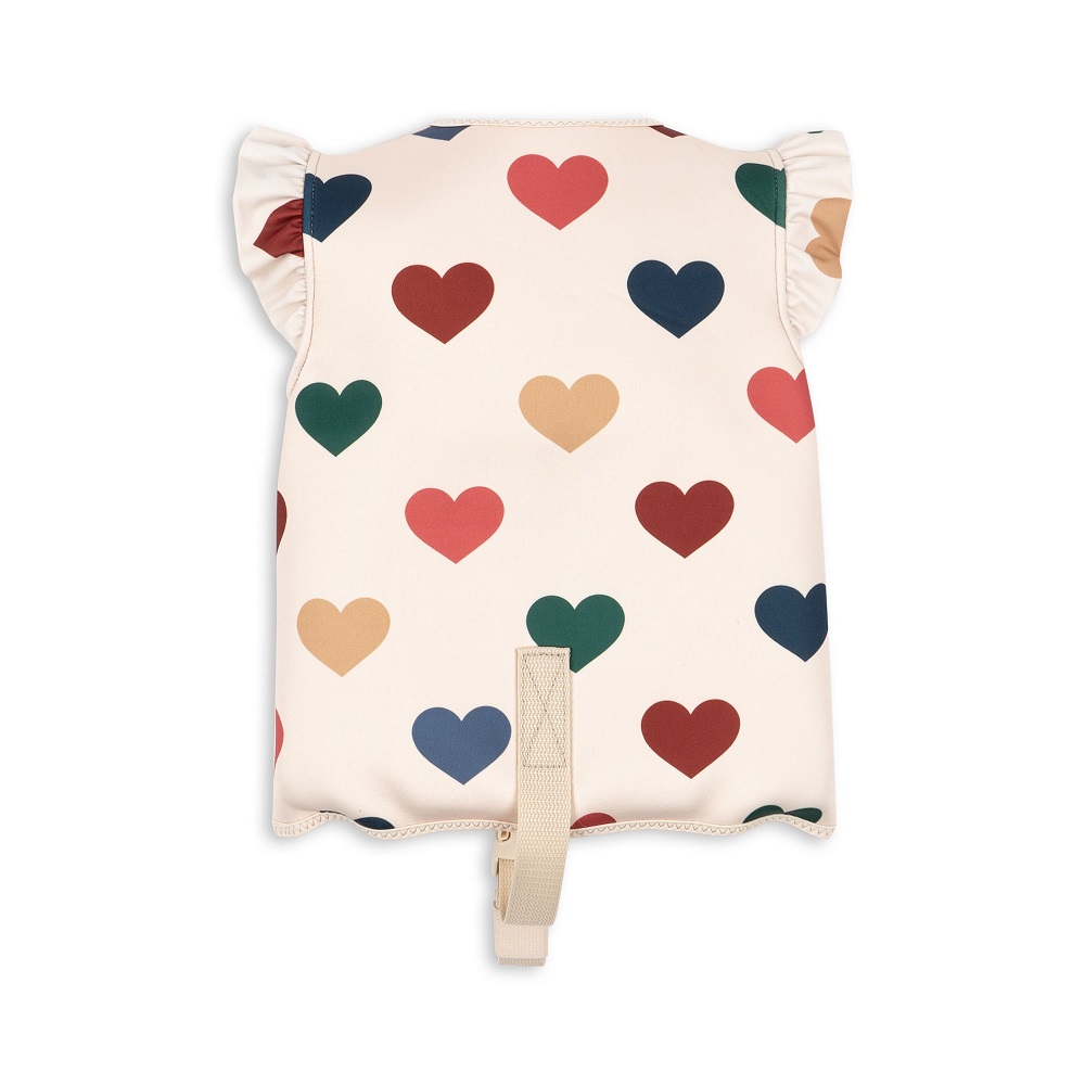 Kinder-Schwimmhilfe, cremefarben, bunte Herz-Muster, Rüschen an den Schultern, Sicherheitsgurt.