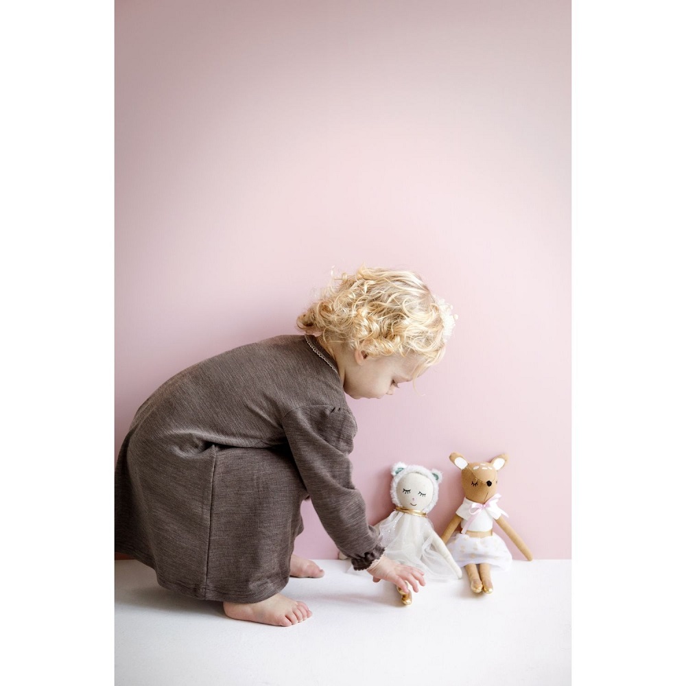 9522107-Schlenkerpuppe-Reh-3 Kind, braunes Kleid; zwei Stoffpuppen; eine mit Bärenohren, weißem Kleid; eine mit rosa Schleife, Rock; Hintergrund rosa.