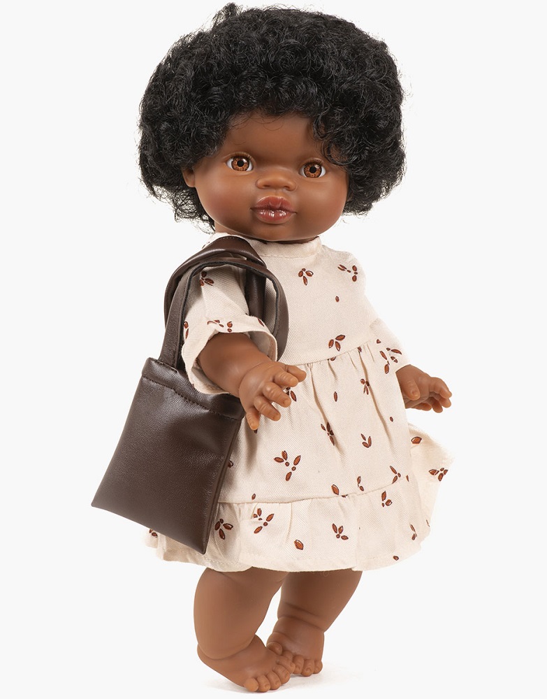 Collection-Minikane-poupee-gordis-nouveautes-automne-hiver-2021-totebag-en-smili-cuir-chocolat-look Puppe, kurze schwarze Locken, cremefarbenes Kleid mit braunen Blättermuster, braune Tasche.
