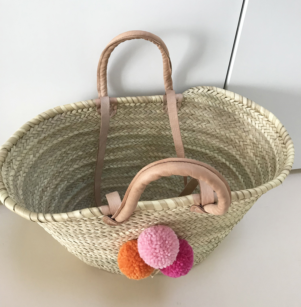 IMG_2583 Korbtasche, geflochten, naturfarben, Henkel aus Leder, Pompons in Rosa, Orange und Pink.